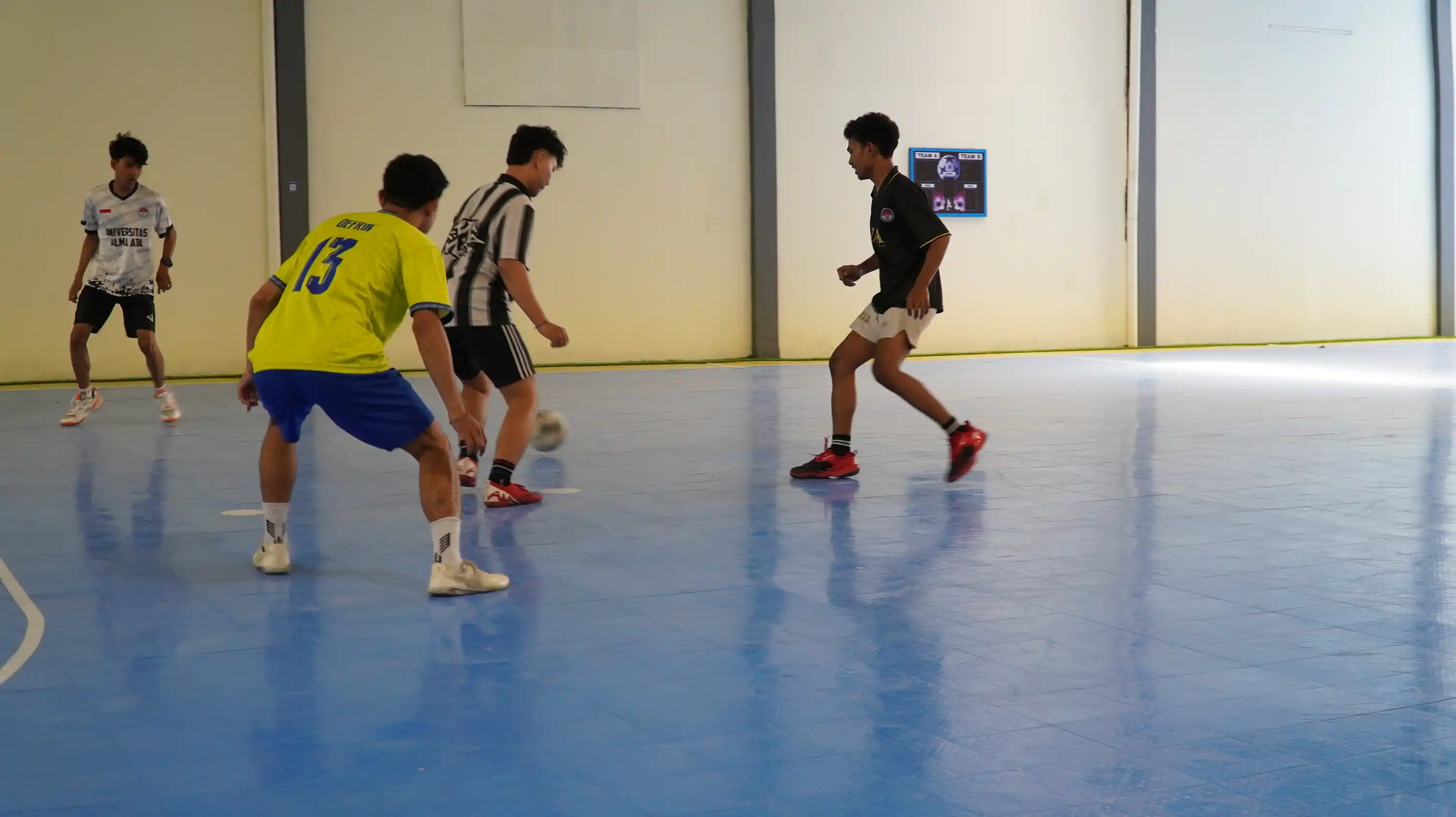 Aksi pertandingan futsal di lapangan indoor